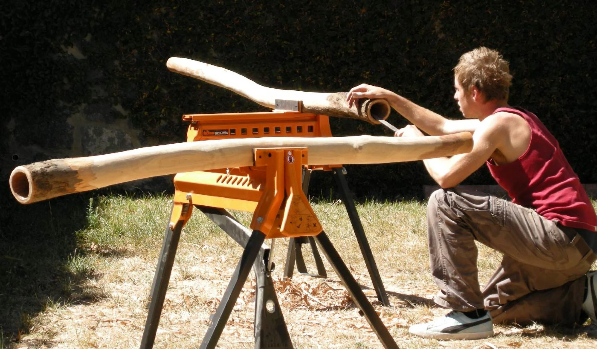Hands-on didgeridoo making session showing the crafting process from raw blank to finished instrument