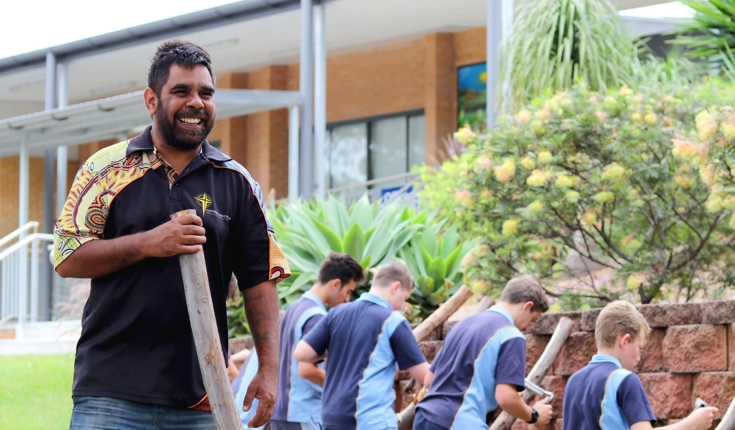 Indigenous elder Uncle Mark sharing traditional didgeridoo knowledge with workshop participants